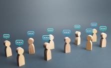 wooden figures with thought bubbles above their heads