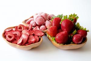 fresh, frozen, and dehydrated strawberries in small bowls
