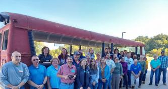 participants standing in front of a melon bus