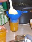 ladling jelly into a jar