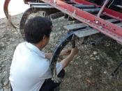 Hmong grower works on farm equipment