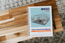Pack Shed handbook on a wooden table