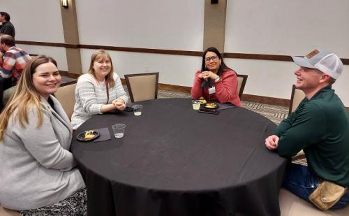 four people sitting around a table