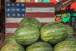 watermelons in front of a painted flag