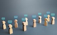 wooden figures with thought bubbles above their heads